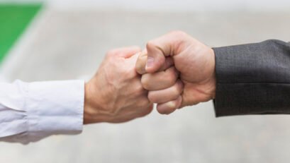 crop-men-bumping-fists